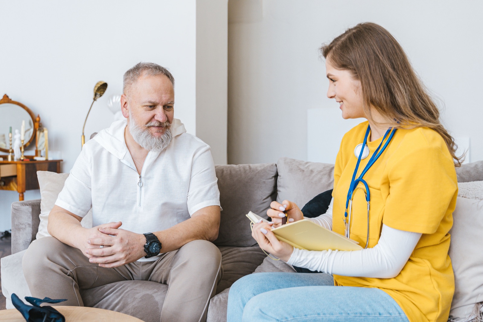 Doctor consulting with an elderly patient at home